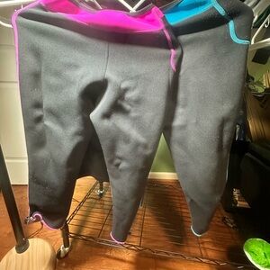 Two pairs of neoprene workout pants. Black/pink & blue/black with neoprene tank